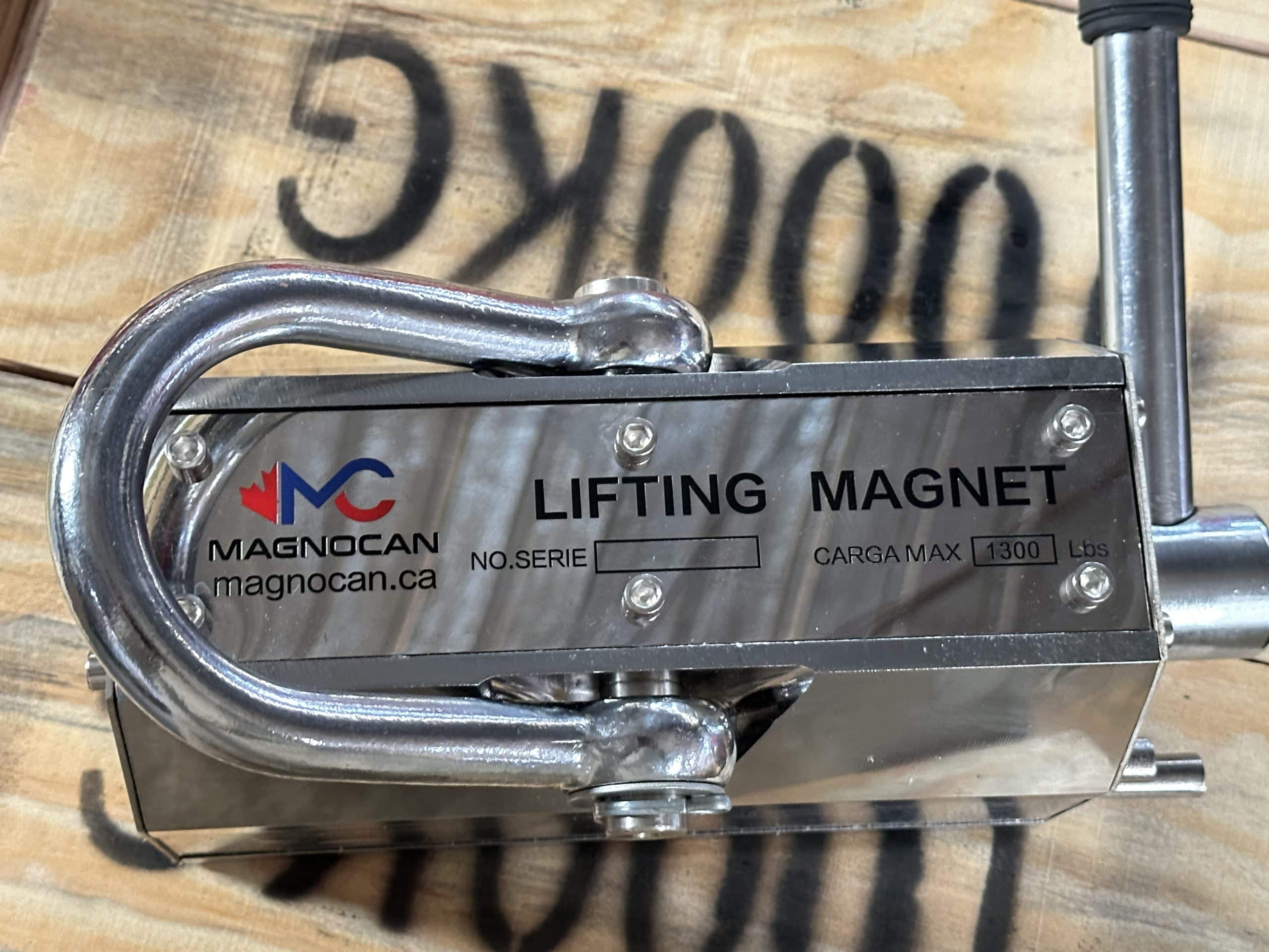 Operator using a lifting magnet in a steel fabrication plant to handle metal sheets
